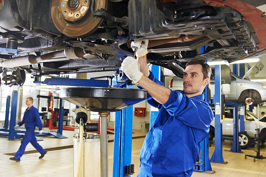 A mechanic servicing a car