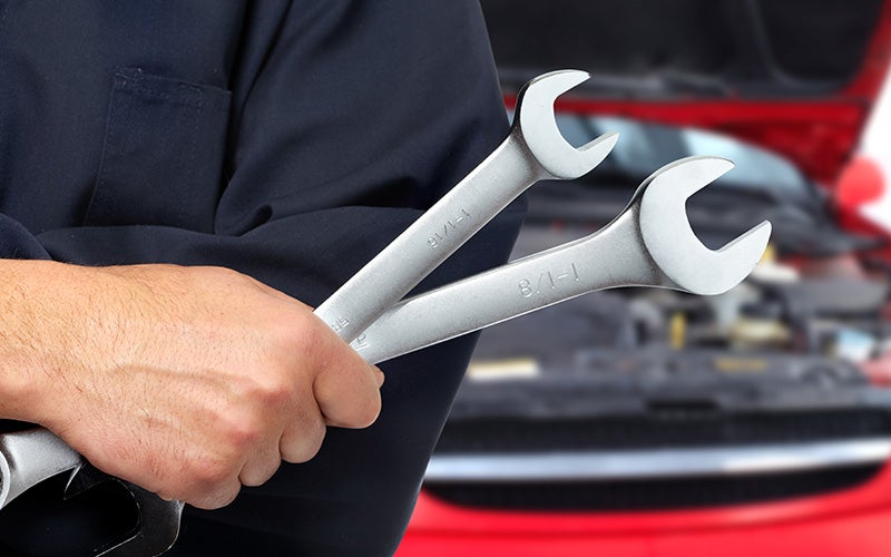 A person holding Wrenches