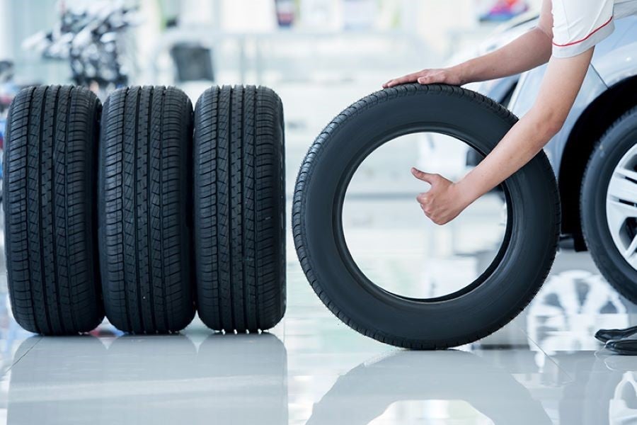 A person showing thumb in holding a tire